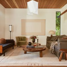 a living room filled with furniture and a wooden ceiling