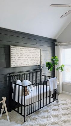 a baby's crib in the corner of a room with white rugs