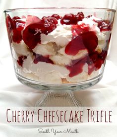 cherry cheesecake trifle in a glass dish with whipped cream and cherries on top