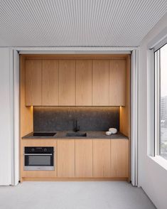 an empty kitchen with wooden cabinets and counter tops