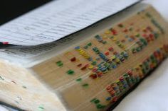 an open book with many colorful pins on it