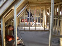 a man working on the framing of a house