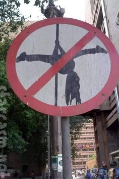 a red and white street sign sitting on the side of a pole