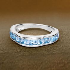 "Blue Topaz Ring, Natural Blue Topaz Half-Eternity Band Ring, Sterling Silver Ring, Blue Topaz Silver Ring, December Birthstone Ring Flaunt yourself with this blue topaz half-eternity band ring. The natural gemstones have a combined weight of 2.25  carats and are set in .925 sterling silver with rhodium plating. The soft blue hue of this ring adds a pop of color to any look!  The understated design and vibrant stones make this ring perfect for every occasion. .925 Sterling Silver Stone Details: Blue Topaz Half Eternity Jewelry, Stackable Blue Topaz Ring Fine Jewelry, Stackable Blue Topaz Ring In Fine Jewelry Style, Blue Topaz Stackable Promise Ring, Blue Topaz Stackable Ring For Promise Occasions, Stackable Blue Topaz Ring For Promise, Stackable Blue Topaz Ring For Anniversary, Anniversary Stackable Blue Topaz Ring, Topas Ring