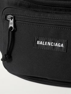 Balenciaga's 'Explorer' belt bag is as practical as it is cool. Made from canvas, it's fitted with two zipped pouches to organise your belongings and has an adjustable fastening. Wear it around your waist or slung over one shoulder. Travel Pouch Bag With Removable Belt, Luxury Everyday Bag With Functional Pockets, Functional Travel Bag With Removable Belt, Luxury Belt Bag With Zipper Pocket For Travel, Designer Belt Bag With Adjustable Strap For Travel, Designer Travel Belt Bag With Zipper Closure, Designer Belt Bag For Travel With Zipper, Designer Belt Bag With Zipper Closure For Travel, Designer Black Belt Bag With Belt Loops