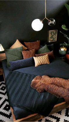 a bed with pillows and blankets on top of it in a room filled with potted plants