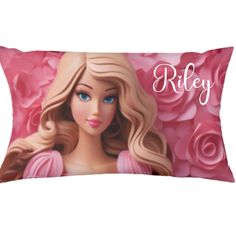 a pillow with a barbie doll on it and roses in the background that says riley