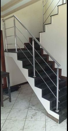 a set of stairs leading up to the second floor in a house with tile floors