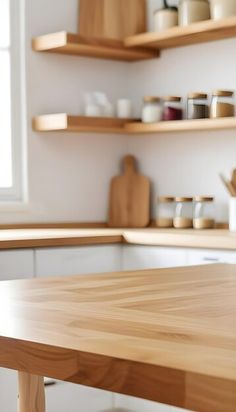 an empty wooden table in a white kitchen