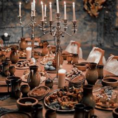 a table is set with candles and dishes