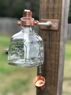 a glass bottle hanging from a wooden post