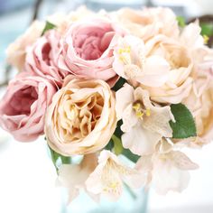 a vase filled with lots of pink and white flowers