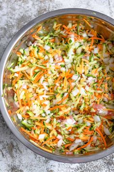 shredded carrots, celery, and onions in a pot on the ground