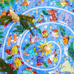 an image of a blue christmas table cloth with animals on it and pine branches in the center