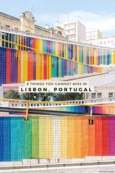 a rainbow colored wall with the words 8 things you cannot miss in lisbon portugal