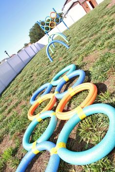 several inflatable rings are lined up on the grass