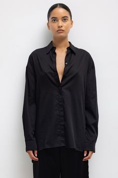 Crafted in our crisp and light Yoko Cotton, the Yoko Oversized Button Down II is an oversized silhouette with drop shoulders, a covered button placket, and a slightly elongated length. Shop all styles in this fabric group Oversized Button-up Top With Concealed Placket, Oversized Button-up Blouse With Placket, Oversized Button-up Blouse With Concealed Placket, Oversized Shirt With Concealed Placket, Oversized Blouse With Button Closure For Daywear, Black Oversized Blouse With Buttons, Oversized Black Blouse With Buttons, Oversized Black Blouse With Button Closure, Satin Set