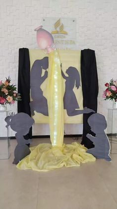 a couple is standing in front of a stage set up for a wedding ceremony with flowers on the floor