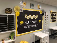 a classroom wall decorated with yellow and black decorations for the school's bee theme