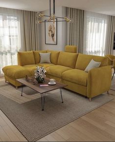 a living room with yellow couches and rugs in front of the windows,