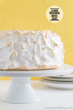 a cake with white frosting sitting on top of a plate