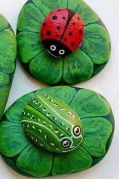 three green leaves with ladybugs painted on them