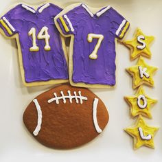 decorated cookies in the shape of football jerseys and stars are displayed on a plate with cookie decorations