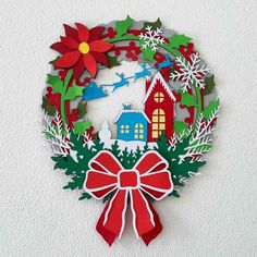 a paper christmas wreath hanging on the wall