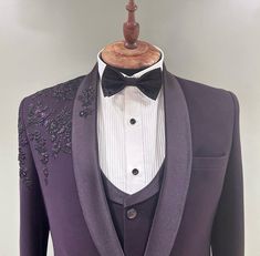 a purple tuxedo with a white shirt and black bow tie