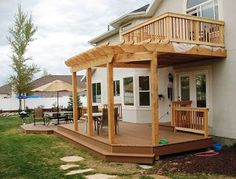 a house with a wooden deck and covered patio