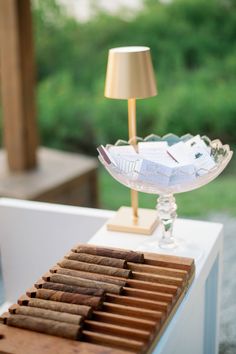 a lamp and some cigars on a table