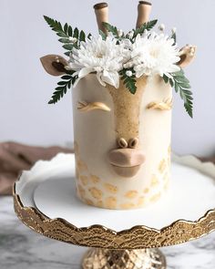 a cake decorated with flowers and giraffe's head