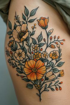 a woman's thigh with flowers and leaves on it