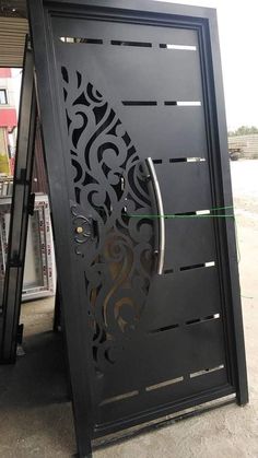 a black door with intricate designs on the front and side panels, which are cut in half