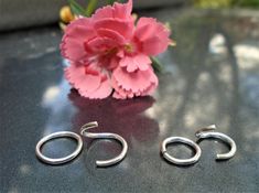 "These simple little hoops measure 10mm outer and 8mm inner diameter and are 1mm thick for the larger      and the smaller one is 8 mm outer - 6mm inner and 1mm thick. Due to requests - I am now making 9mm twist open hoops they measure 7mm inner - same 1mm thick wire These are simple twist open earrings with no hinge or clasp. Each piece has been buffed on the ends so it has no sharp edges. To use: Do NOT Pull ends apart. Twist Open one end and move it away from the other end (Twist Slightly upwards or down)  Put in desired spot and twist it shut again. You may need to squeeze it together  slightly to make to two sides touch. See Photo.  To see all my other items go toStudioJAndrel.etsy.com Thanks for Looking!   :) Also you can follow me on instagram or facebook    Mark My Shop as in your Cheap Earrings, Minimalist Gifts, Pillow Box, Jewelry Earrings Hoops, Solid 925 Sterling Silver, Post Earrings, Something To Do, Twist, Hoop Earrings