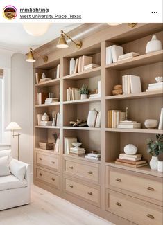 a wooden bookcase filled with lots of books and vases on top of it