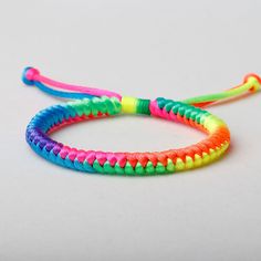 two colorful bracelets on a white surface