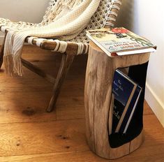 a wooden chair sitting next to a bookshelf with a book on top of it