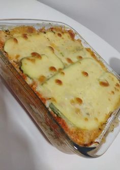 a casserole dish with cheese and vegetables in it