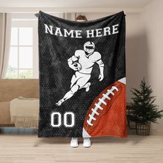 a football player holding up a personalized blanket