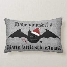 a batty little christmas pillow with a santa hat on it