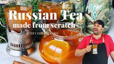 a man standing in front of a table filled with tea