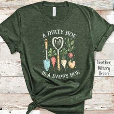 "Add a touch of humor to your gardening with our \"A Dirty Hoe is a Happy Hoe\" Funny hoeing Shirt! This shirt is perfect for enjoying some time in the garden or as a gift for a gardener, plant lover or farmworker. Embrace the joy of gardening with a lighthearted twist by wearing our hoeing Funny Shirt. PRODUCT KEY Unisex Tshirt Comfort Colors and extremely soft .: 100% ring-spun cotton .: Medium fabric (6.1 oz/yd² (206.8 g/m .: Relaxed fit .: Sewn-in twill label Made in USA 100% SIZING CHART UNISEX Adult XS, S, M, L, XL, XXL and 3XL are available Remember to go up 2 sizes than your regular to get the oversize effect!! Please check the size chart to make sure you are ordering the correct size for you before clicking the buy button. CARE DIRECTIONS -Machine wash, inside out on gentle, tumbl Gifts For Garden Lovers, Cute Gardening Outfits, Gardening Outfits, Gardening Tshirt, Gardening Shirts Funny, Garden Shirt, Gift For Gardener, Farmer Shirt, Gardening Gift