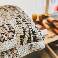 a pair of slippers sitting on top of a bed next to a wooden table