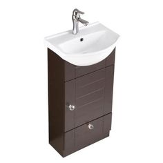 a white sink sitting next to a brown cabinet on top of a wall mounted faucet