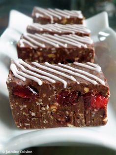 three pieces of chocolate and strawberries bars on a white plate