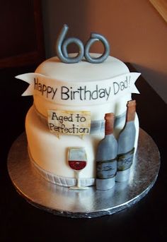 a birthday cake with wine bottles and glasses on it