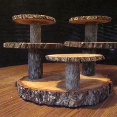 three wooden stools sitting on top of a wooden table