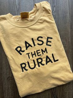 The most comfortable tee! Customize your t shirt with  the thread color of your choice!  EMBROIDERED DESIGN features a large bold font that reads "Raise Them Rural" OTHER SIZES AND COLORS AVAILABLE UPON REQUEST This shirt is Comfort Colors! .: 100% ring-spun cotton .: Medium fabric (6.1 oz/yd² (206.8 g/m .: Relaxed fit .: Sewn-in twill label **Each item is made to order, therefore we can not accept returns and exchanges. HOWEVER, if there is an issue with your order PLEASE contact us before leav Fun Mom Shirts, Farm Mom Aesthetic, Farm Aesthetic Country Living, Farming Shirts, Farming Family, Cute T Shirts, Mom Tshirt, Trendy Graphic Tees, Country Shirts