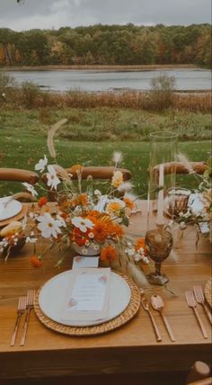 the table is set with flowers and place settings